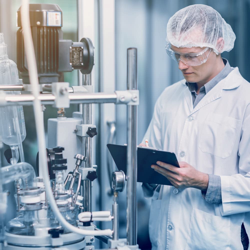 Engineer inspecting pharmaceutical process equipment